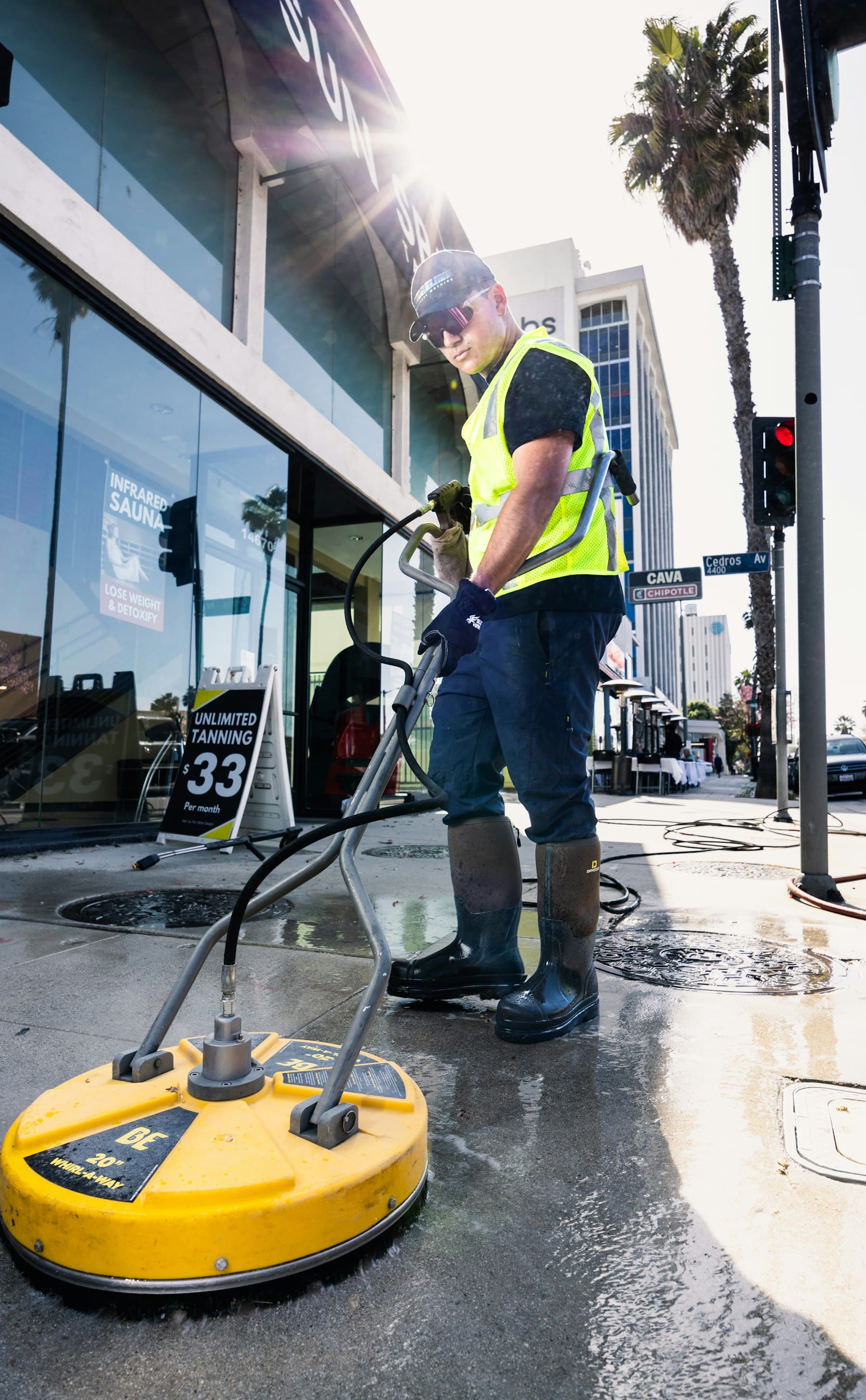 Street paving being pressure washed
