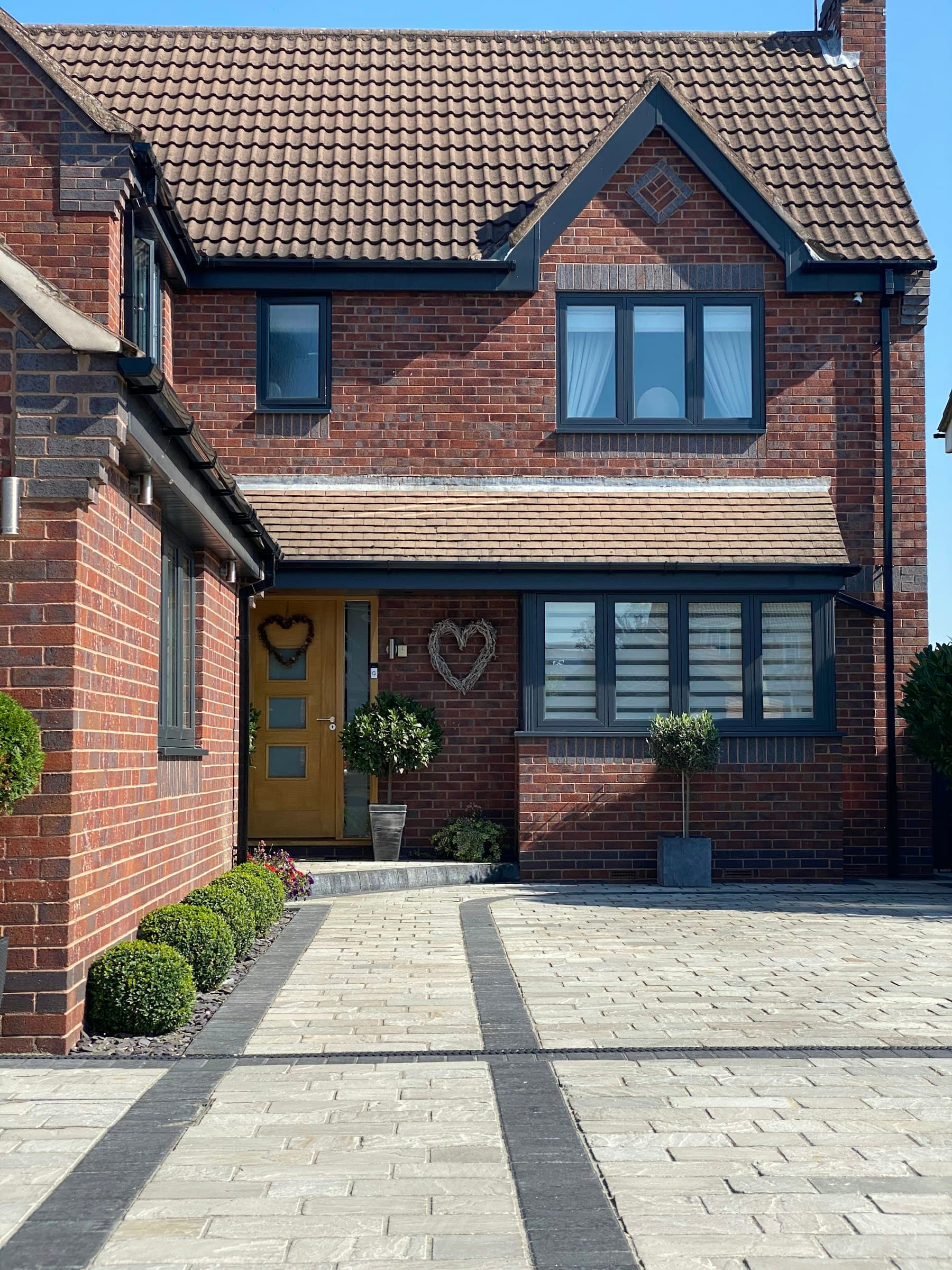 Brick house with a clean paved driveway